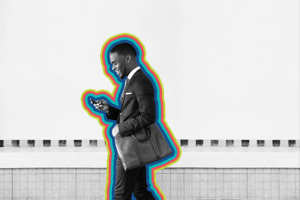 A man in business suit checks his phone to find sms marketing messages.