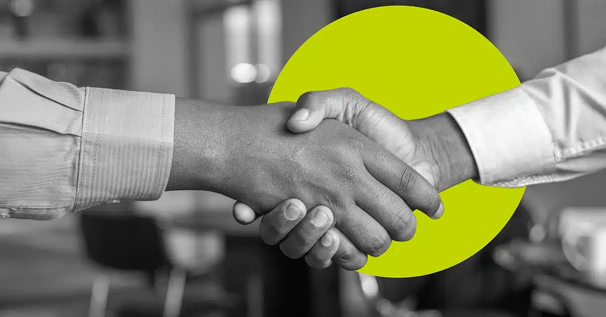 Black and white handshake with yellow circle in background.