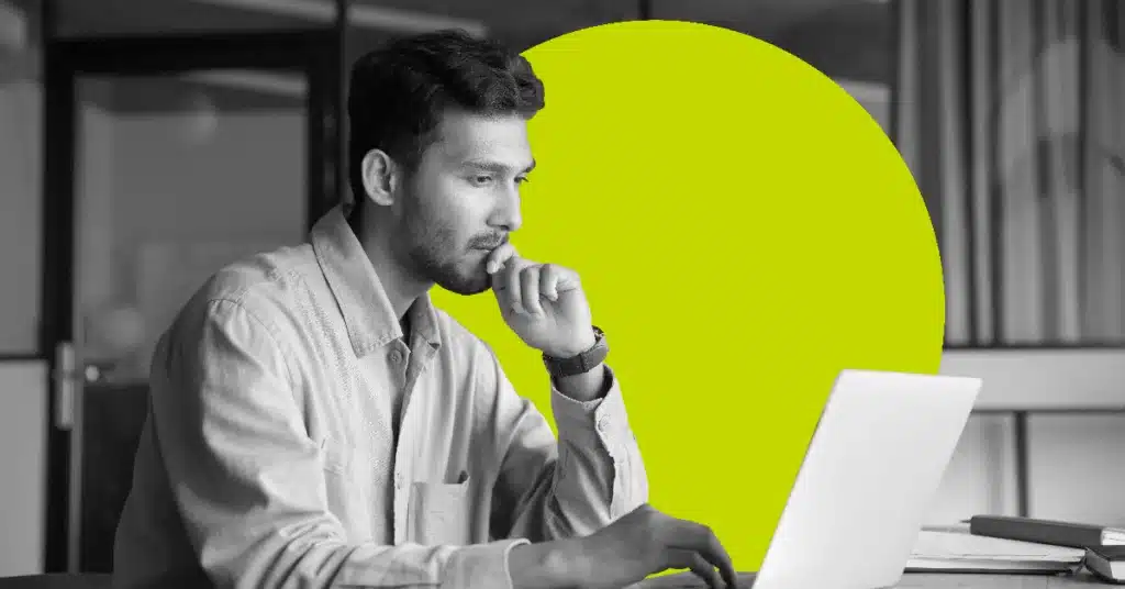 A man focuses intently on a laptop screen on internal marketing automation.