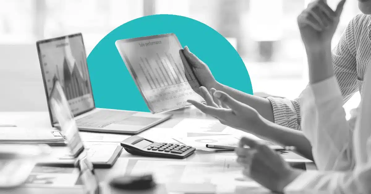 Several laptops with various data on screen during a business meeting.