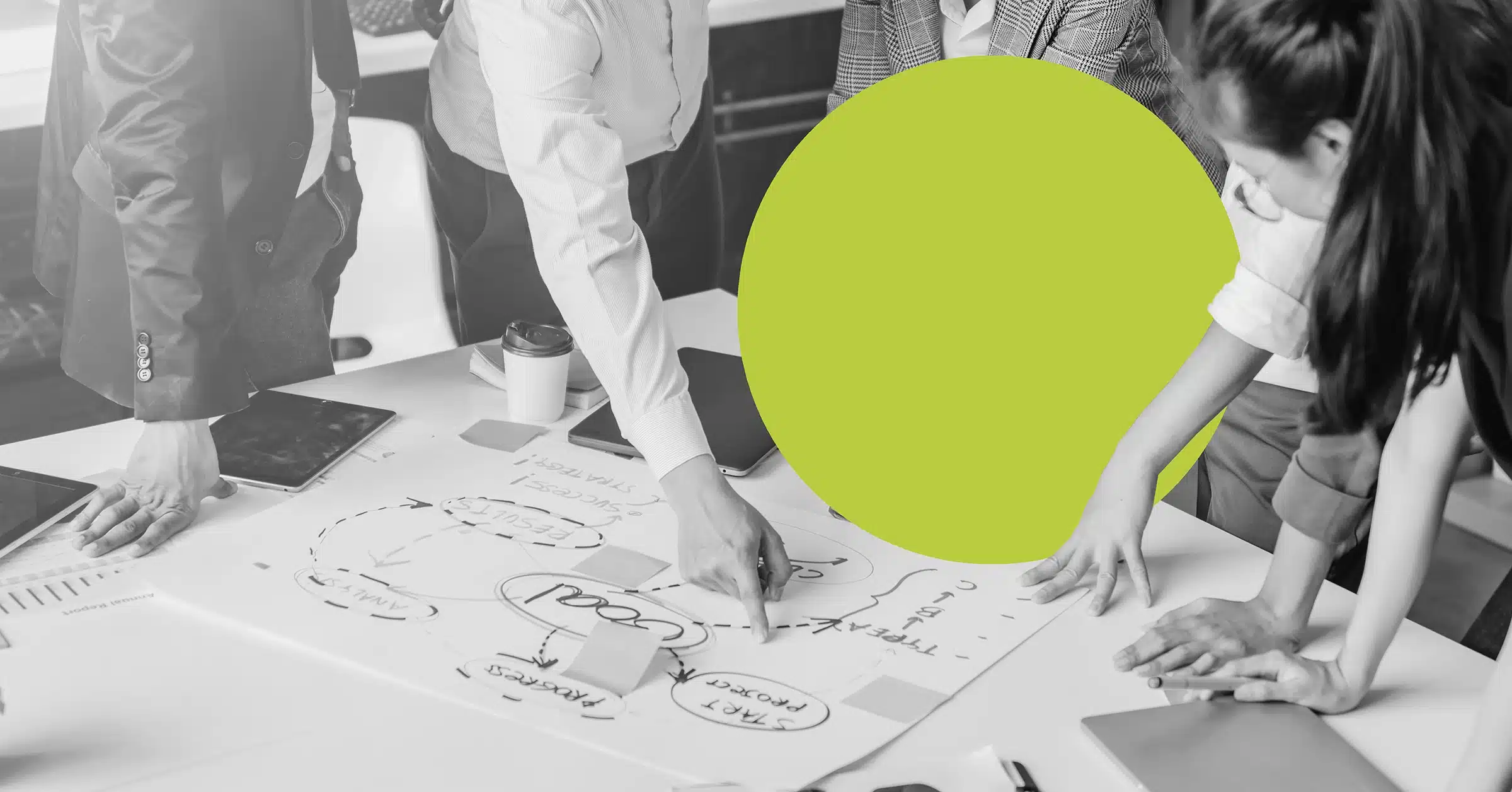 executives pointing to a lead generation strategy for manufacturing laid out on an office table.