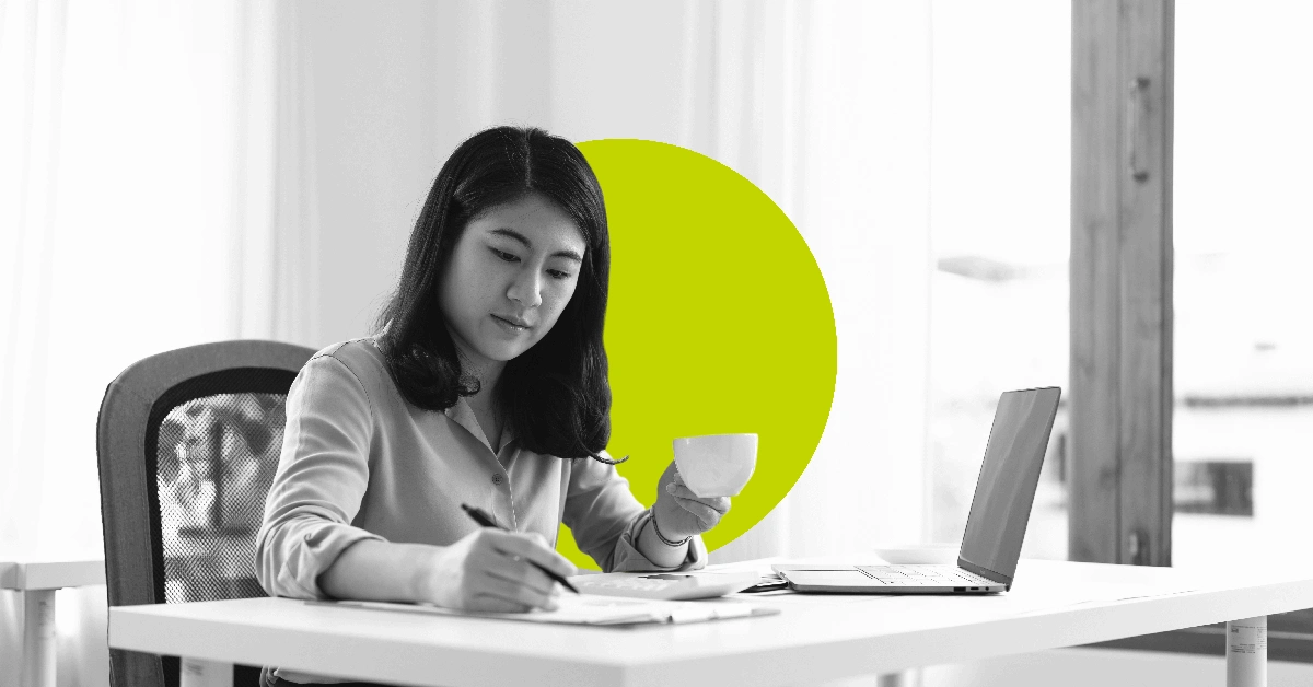 Woman writing out marketing plan components in a notebook.