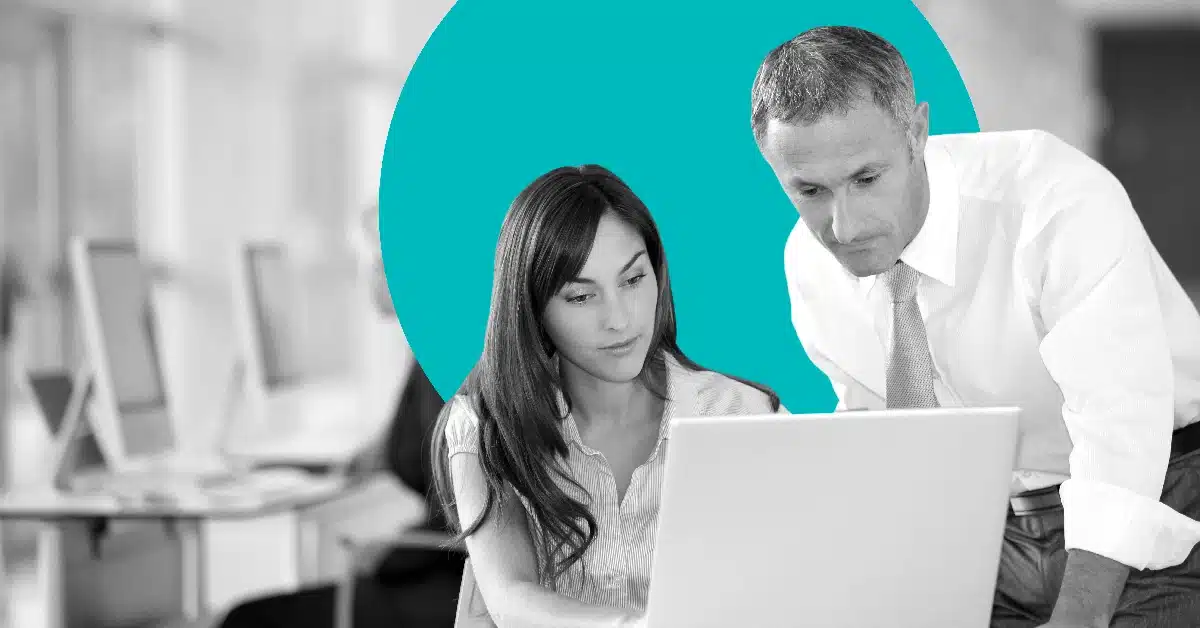 Two marketers looking at a computer screen as they implement marketing power words into a campaign.