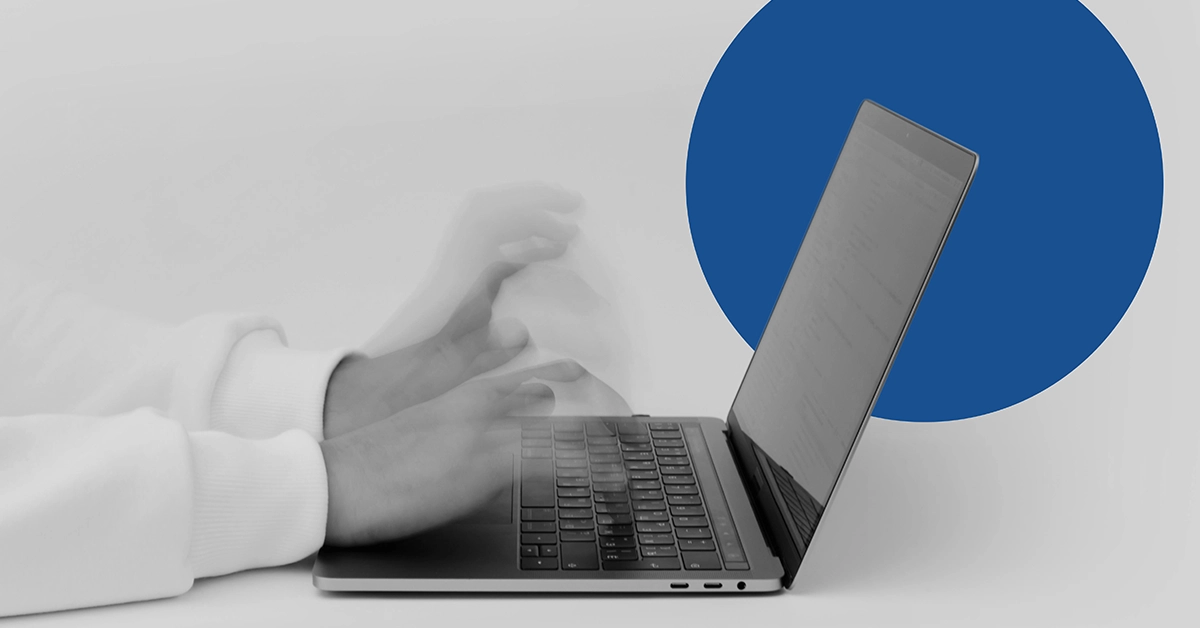 Closeup of a pair of hands typing on a computer keyboard conducting an on-site SEO audit.