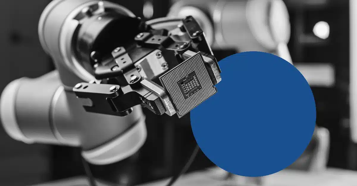 Robotic arm at manufacturing plant holding a microchip.