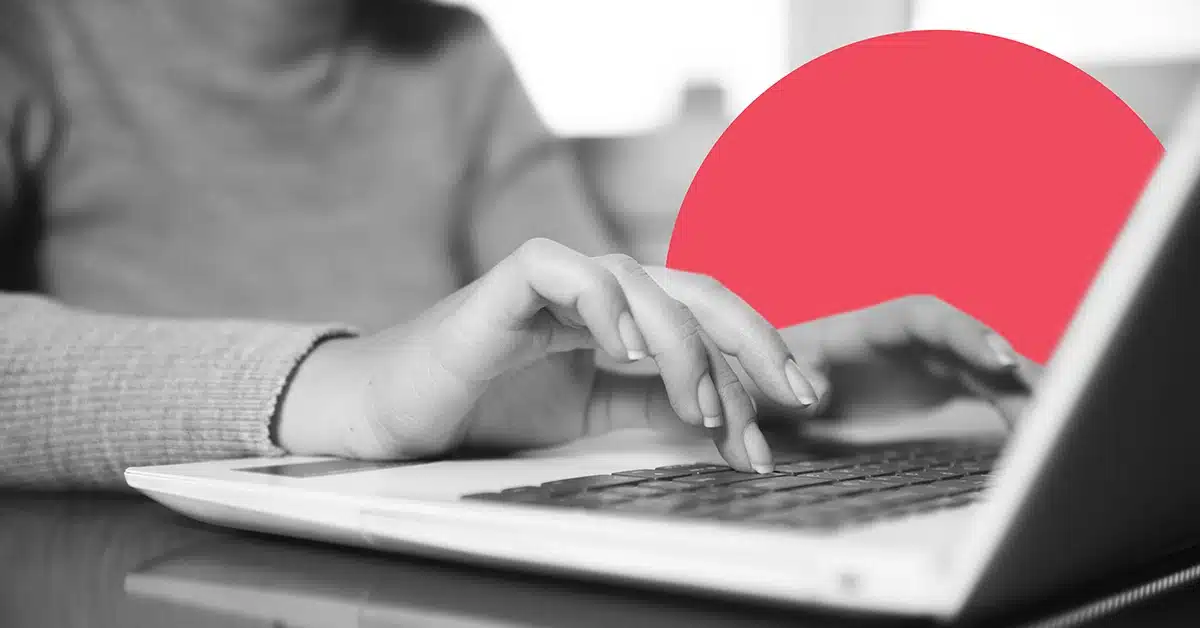 Closeup of a person sending an email on a laptop.