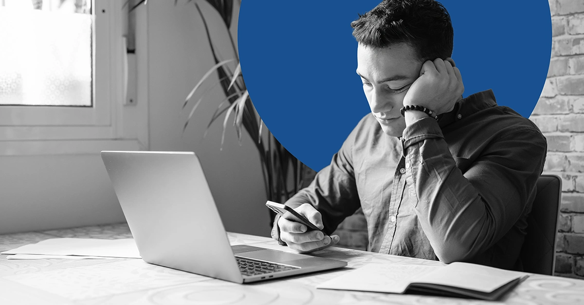 Man sitting at a desk looking for solutions to SEO mistakes.